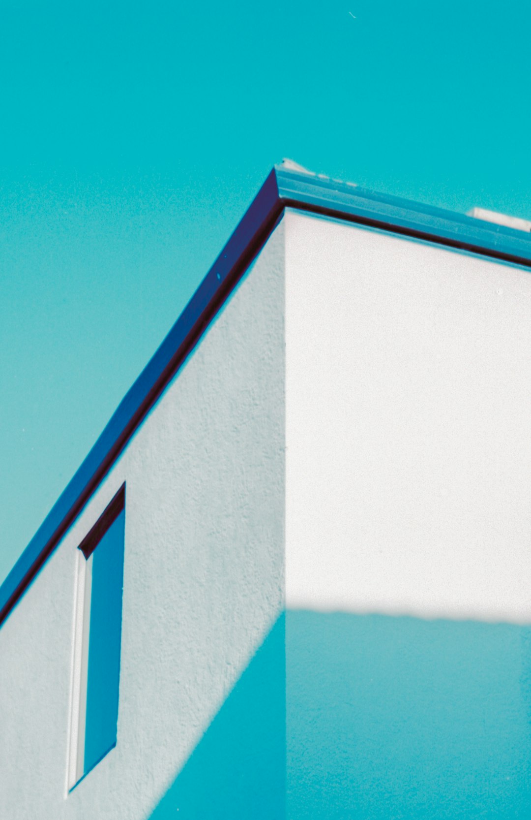 white and blue concrete building under blue sky during daytime