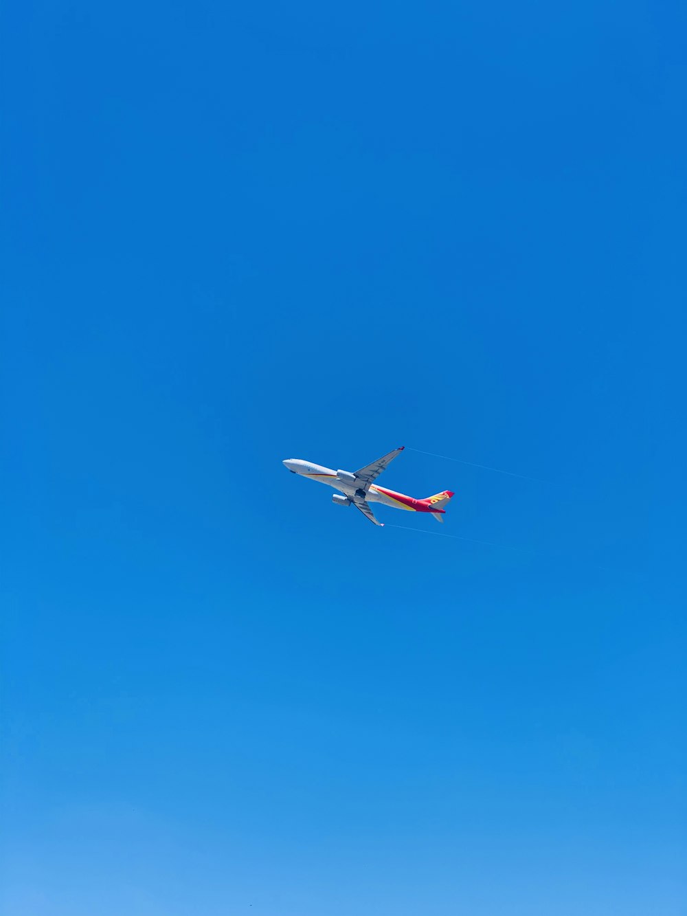 white and red airplane in mid air