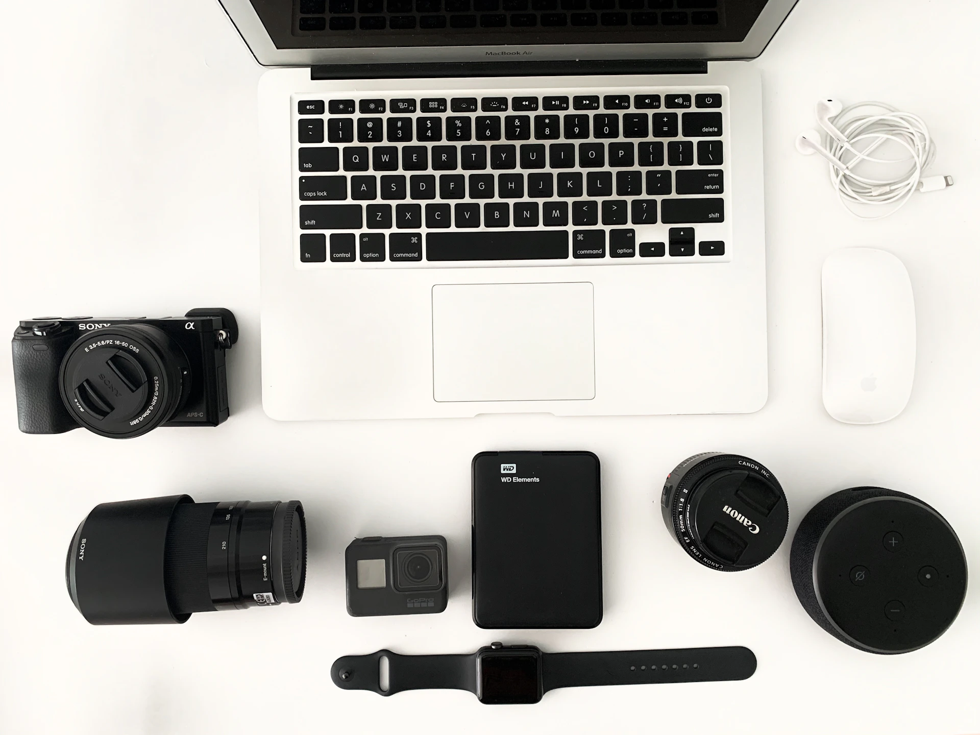 black camera lens beside macbook pro