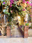 A cozy garden gate framed by blooming flowers at sunset.