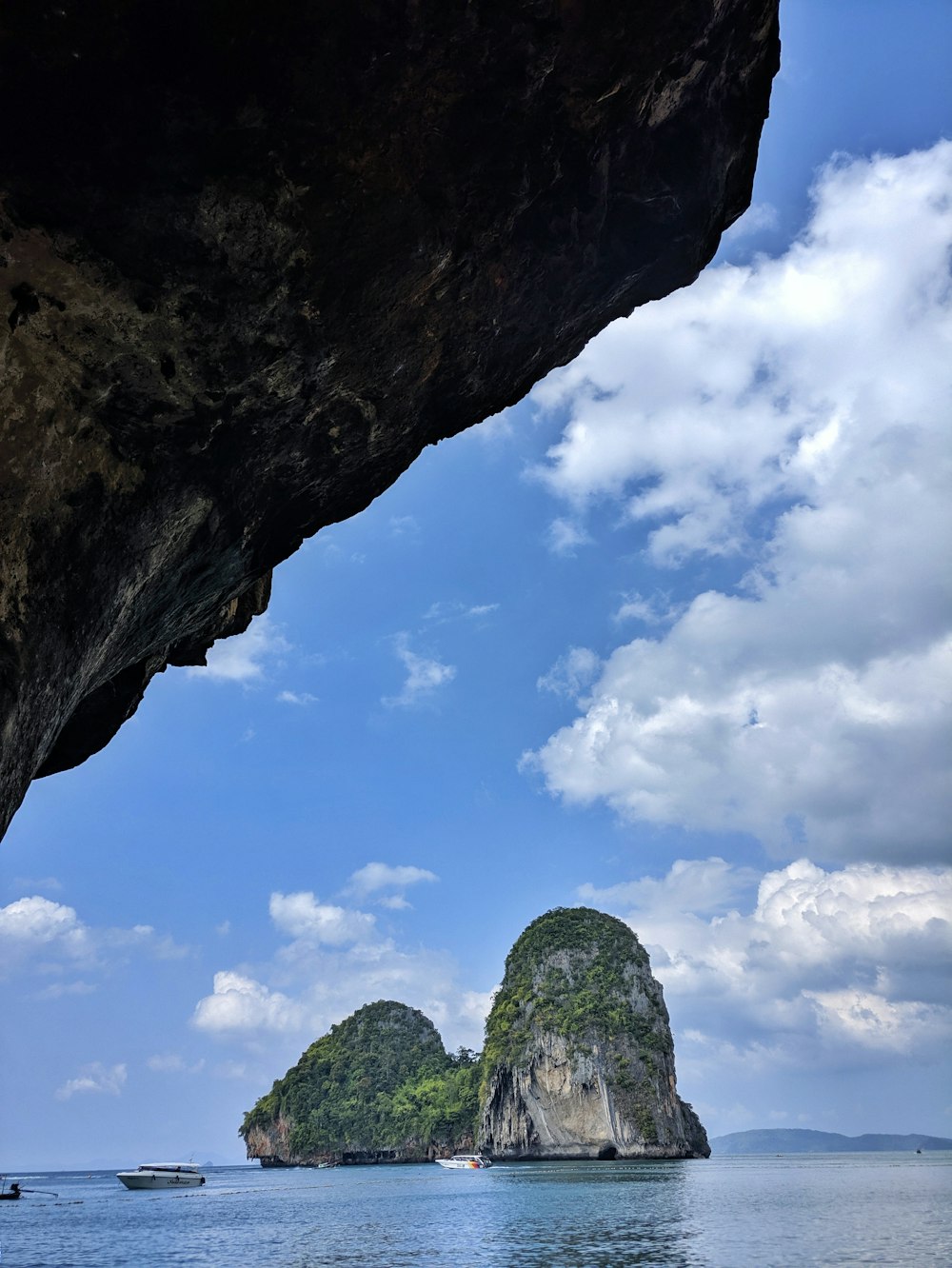 brown rock formation under blue sky and white clouds during daytime