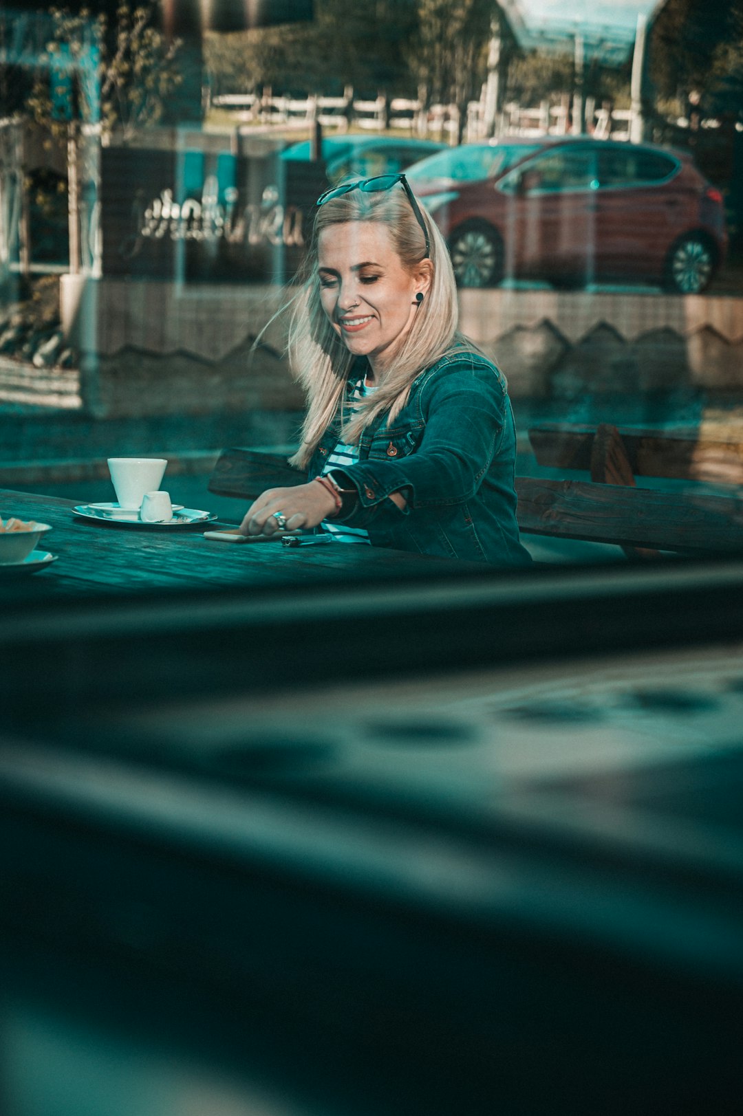 woman in blue long sleeve shirt wearing eyeglasses sitting on chair