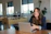 woman in brown cardigan using silver macbook