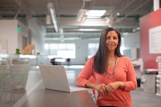 Portrait of Sandra Chavez smiling confidently in a sleek, modern office setting.
