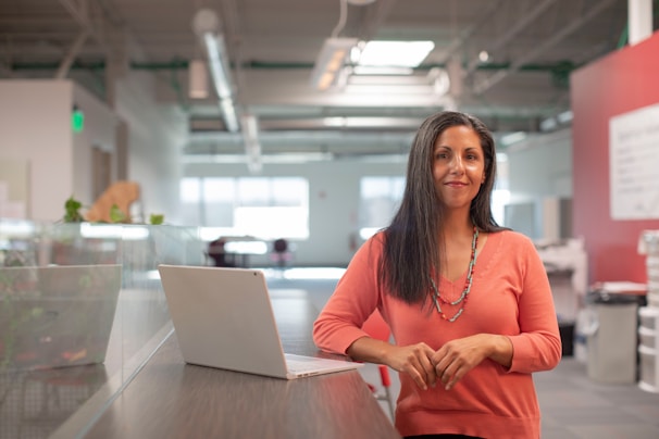 Portrait of Sandra Chavez smiling confidently in a sleek, modern office setting.