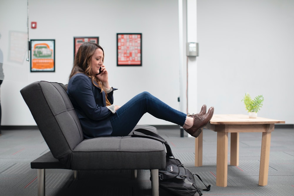 woman in blue denim jeans sitting on black office rolling chair