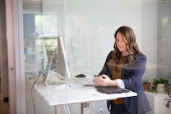 woman in black leather jacket using macbook air