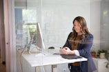 woman in black leather jacket using macbook air