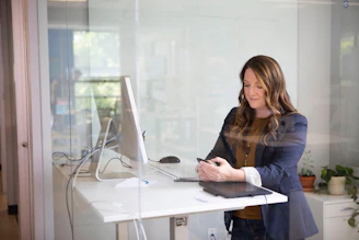 Professional female environmental engineer reviewing project plans in a modern office.