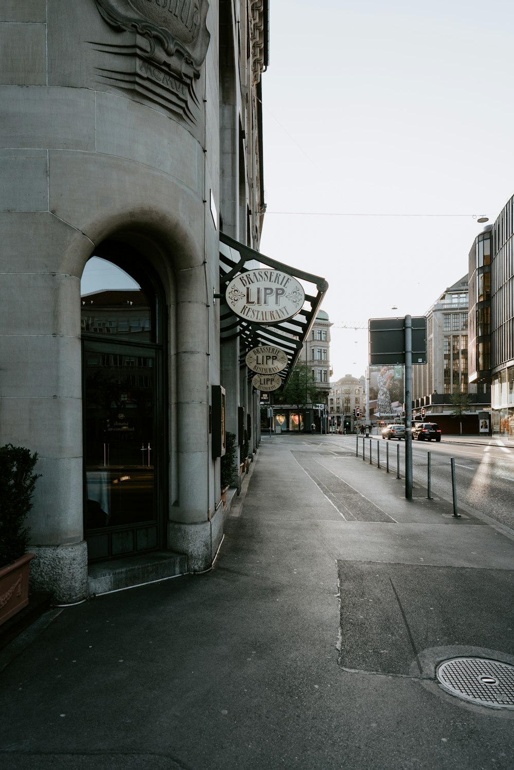 gray concrete road between buildings during daytime