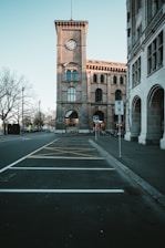 brown concrete building near bare trees during daytime