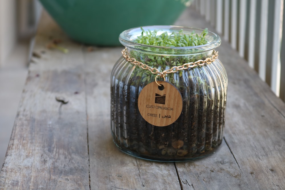 clear glass jar with brown wooden heart shaped pendant