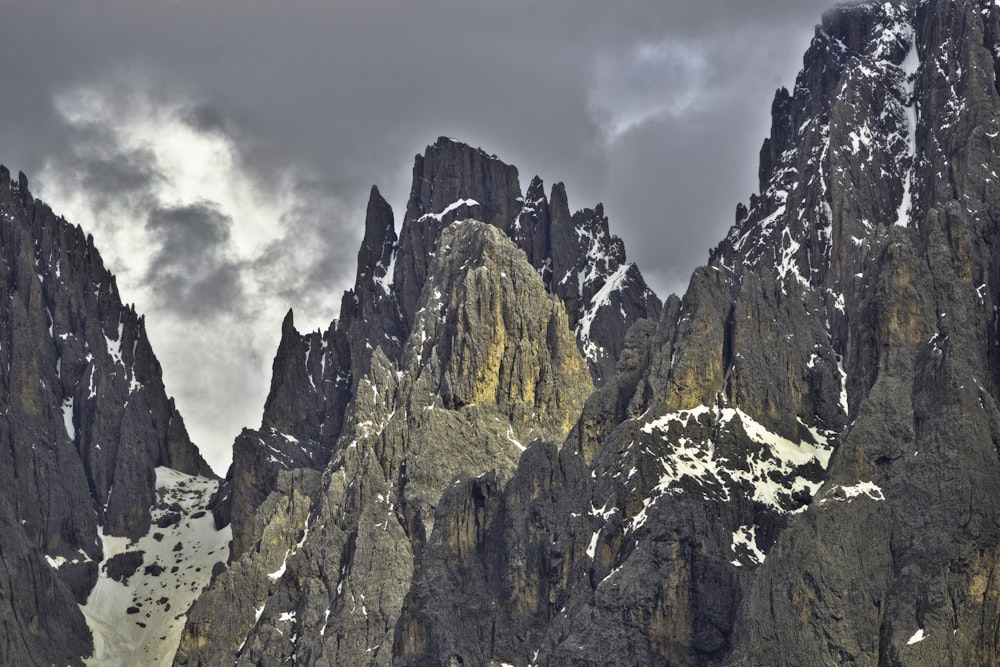 brown rocky mountain under white clouds during daytime