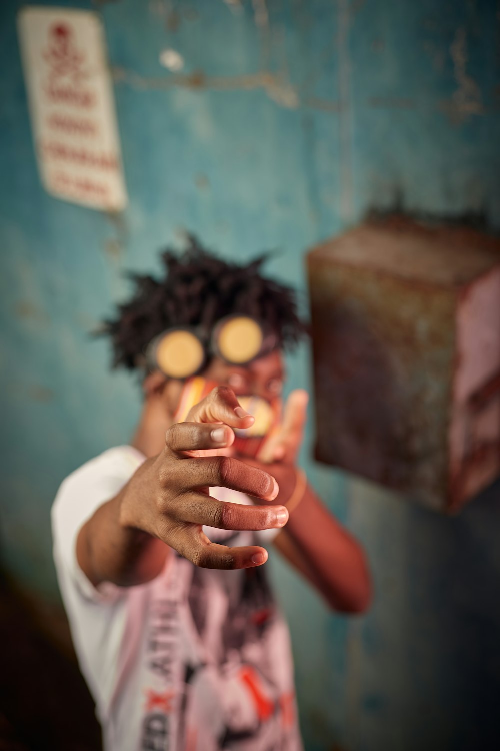 person holding orange fruit in tilt shift lens