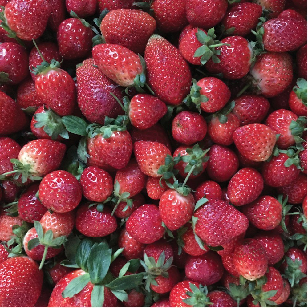 red strawberries on green leaves