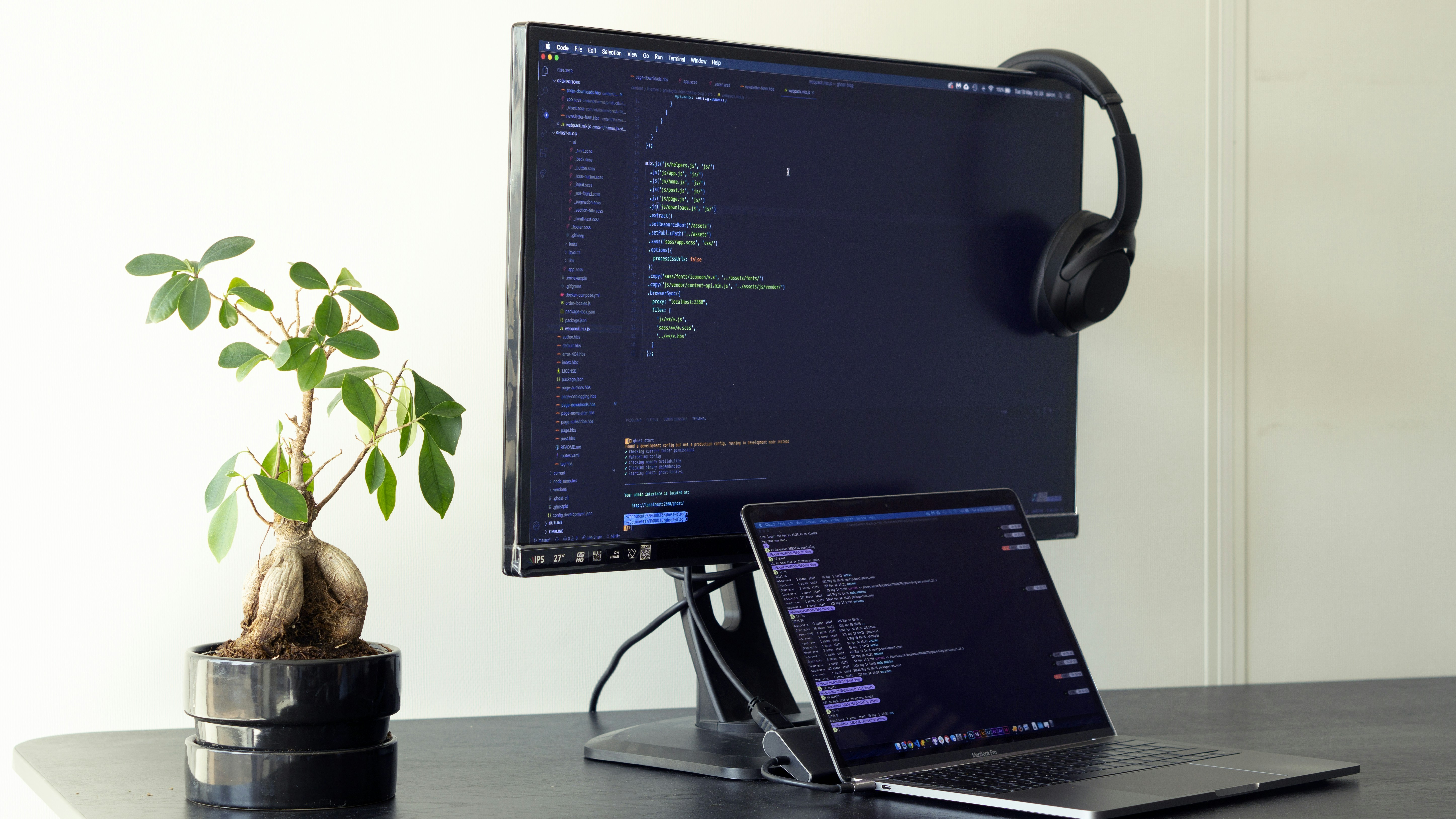 black flat screen computer monitor turned on beside black laptop computer