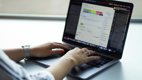 person using macbook pro on table