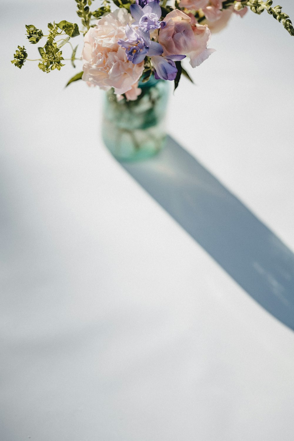 blue and green flower on white textile