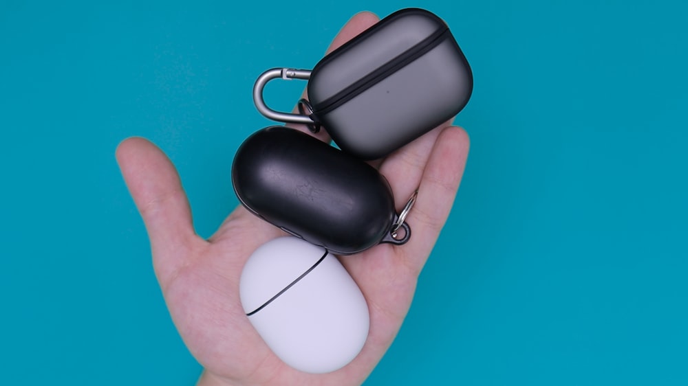 person holding white and black ceramic mug