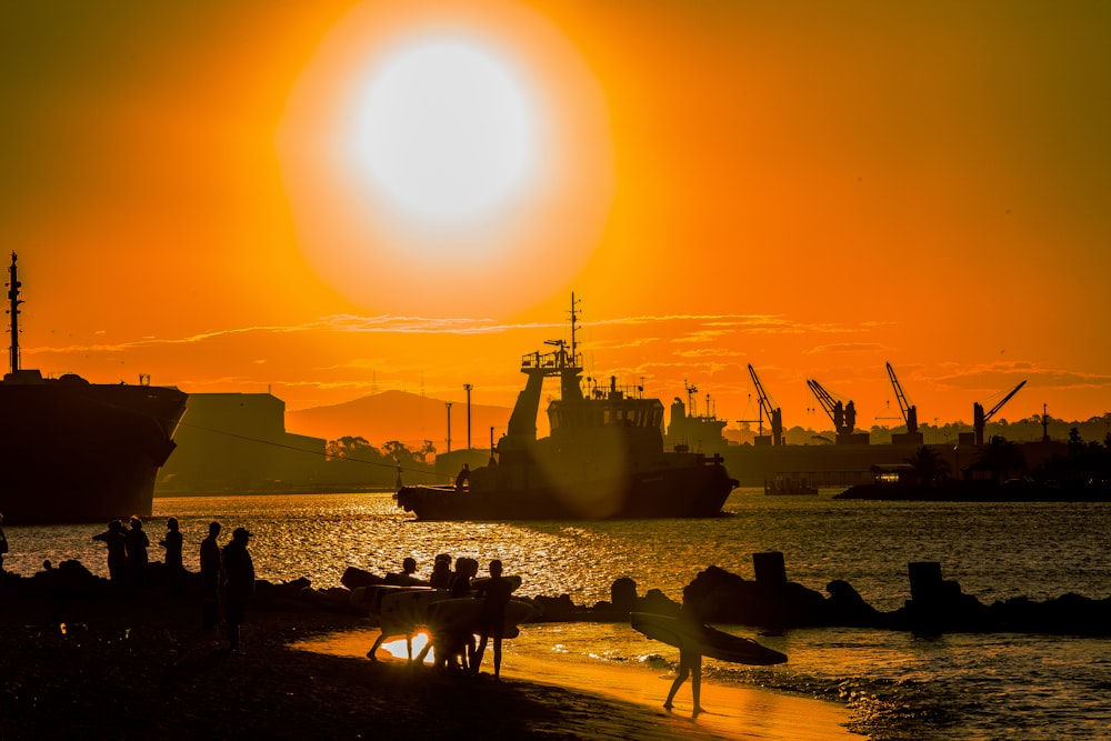 silhouette of people on beach during sunset