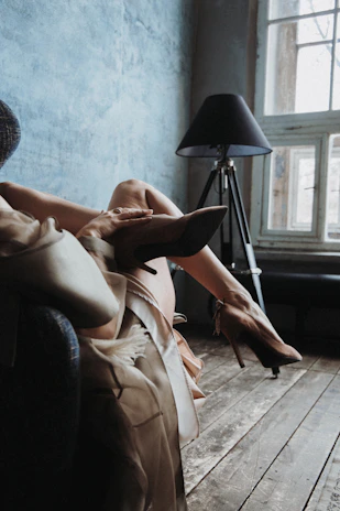 Soft ivory silk sleepwear draped on a plush espresso brown chair.