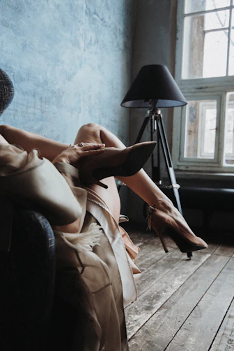 Soft ivory silk sleepwear draped on a plush espresso brown chair.