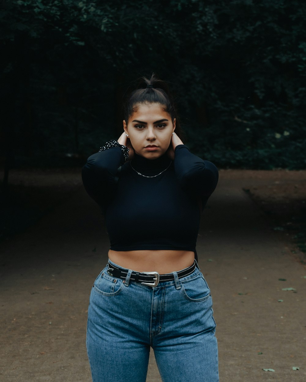 a woman in jeans and a black top