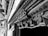 Ornate and intricate wooden carvings adorn a structure, displaying detailed patterns and craftsmanship. The carvings include floral and geometric motifs along a wooden beam or doorway, highlighting the skill and artistry involved.