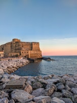 brown concrete building near body of water during daytime