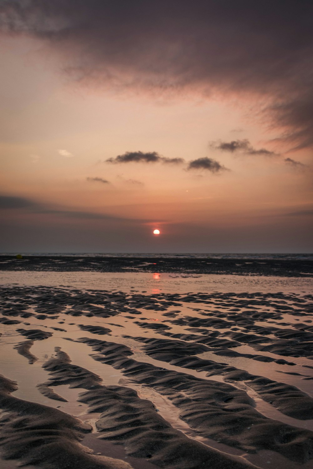 sea waves crashing on shore during sunset