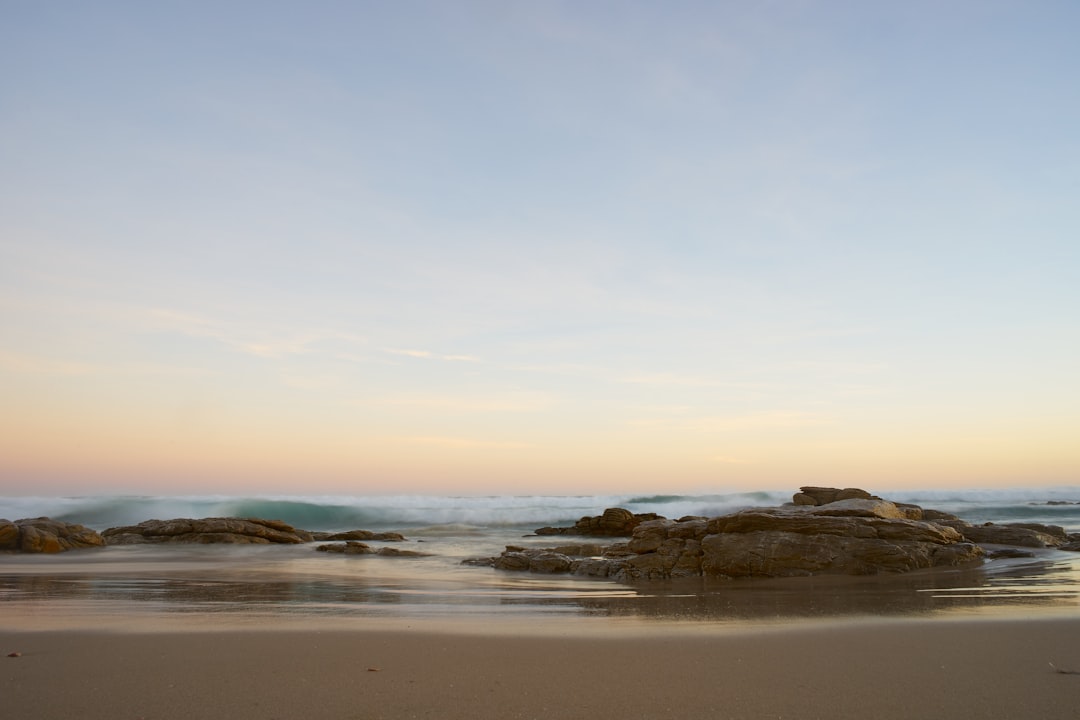 brown rock formation on sea shore during daytime