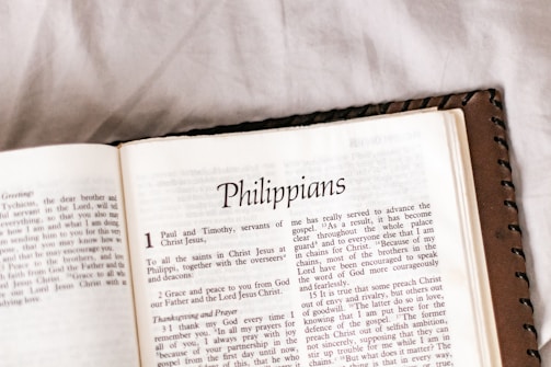 An open page of a book is displayed, specifically showing the beginning of the book of Philippians. The text is in English and the page layout includes chapter and verse numbers in a clear font.