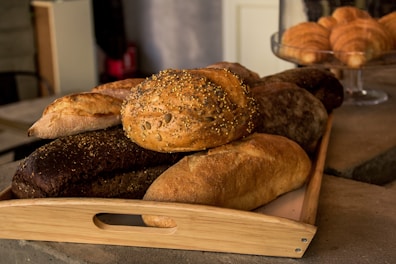 Close-up of artisanal breads and baked goods arranged on wooden trays