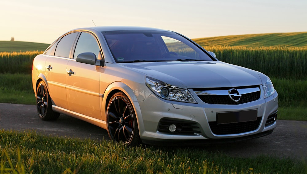 yellow mercedes benz c class on green grass field during daytime