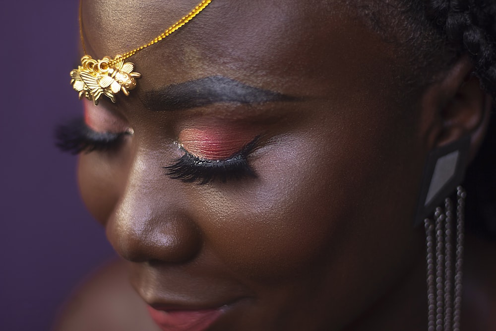 woman with gold flower on her face