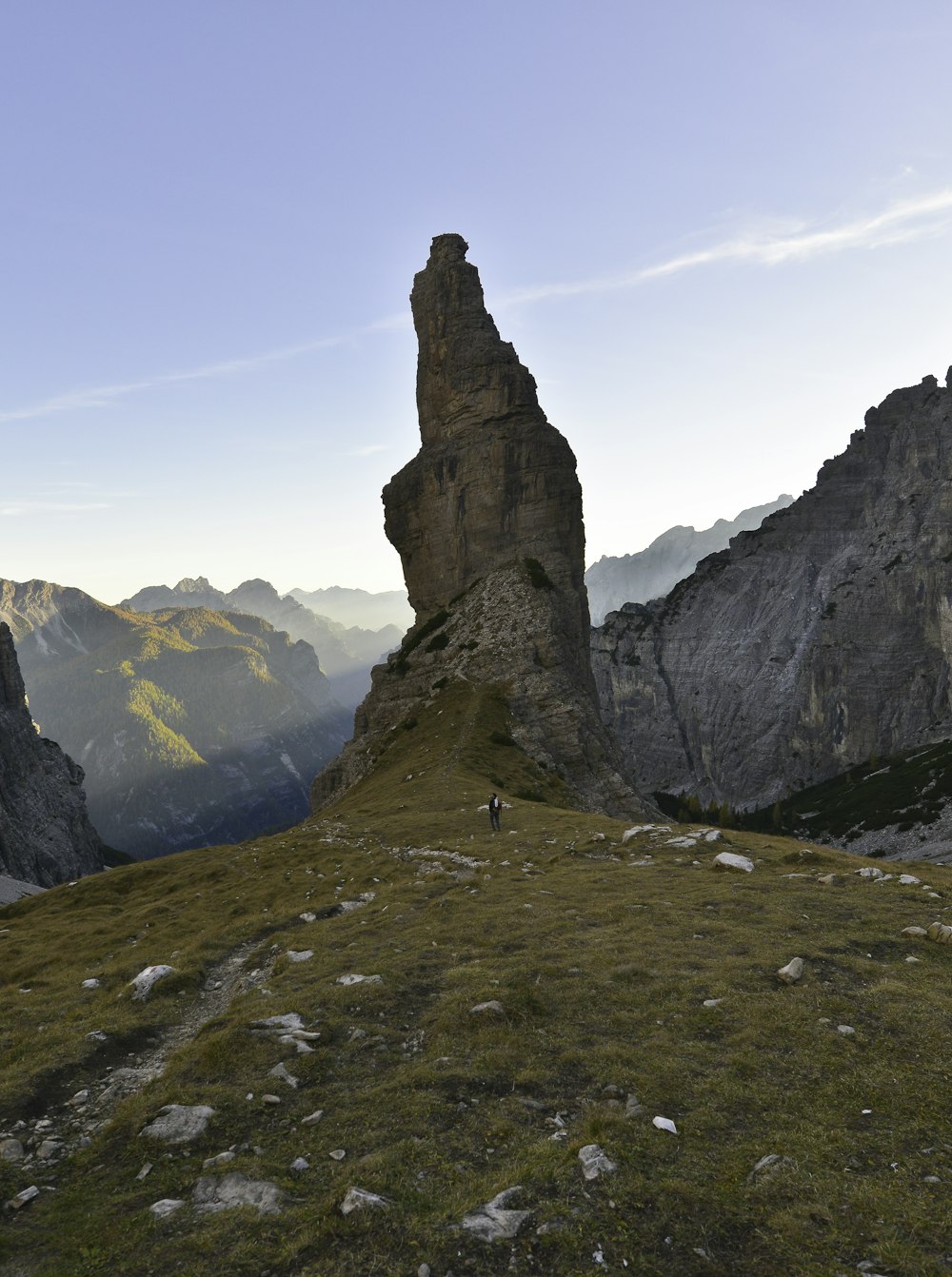 brown rock formation on green grass field during daytime