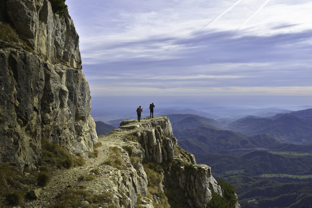 person standing on rock formation during daytime