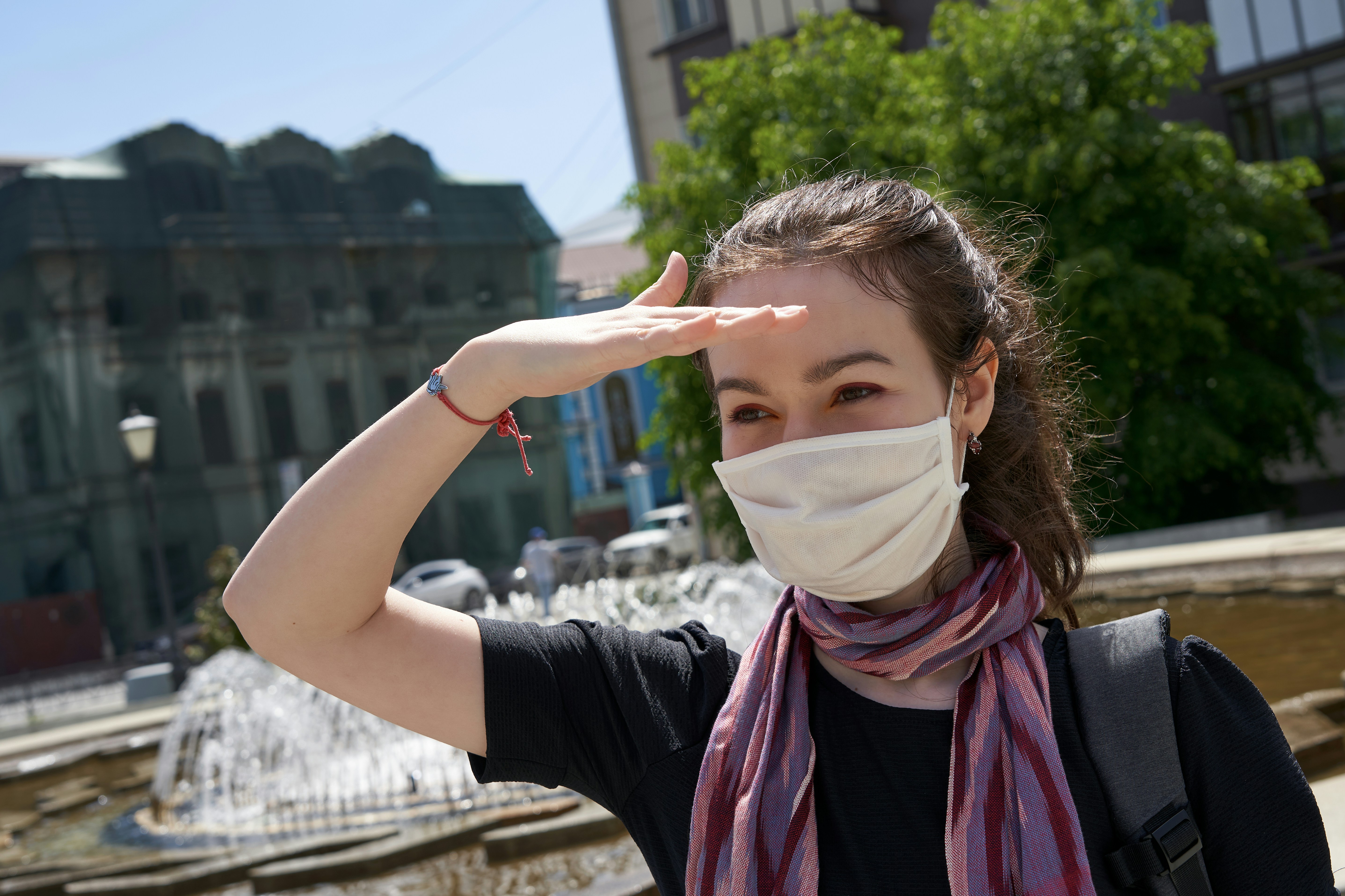 woman in black long sleeve shirt covering her face with white mask