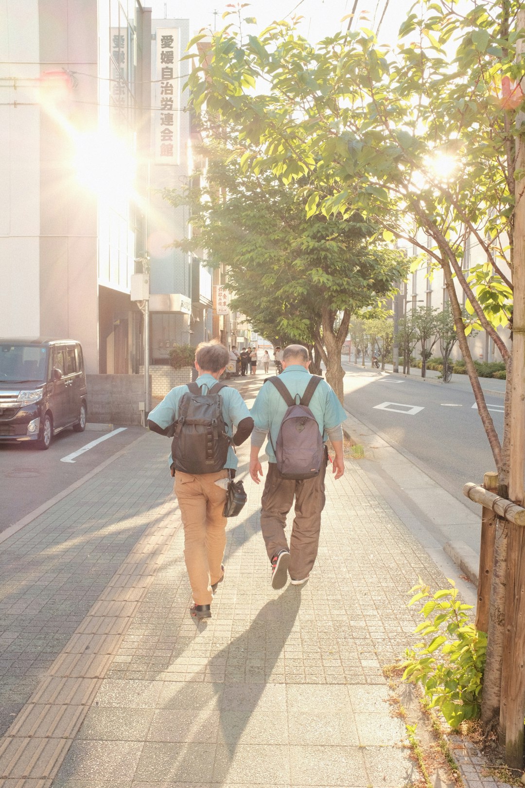 man and woman walking on sidewalk during daytime