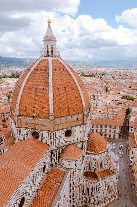 brown and white concrete building in Cathedral of Santa Maria del Fiore Italy