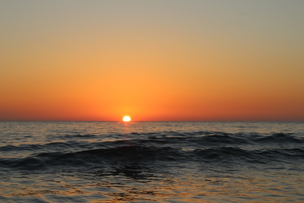 body of water during sunset