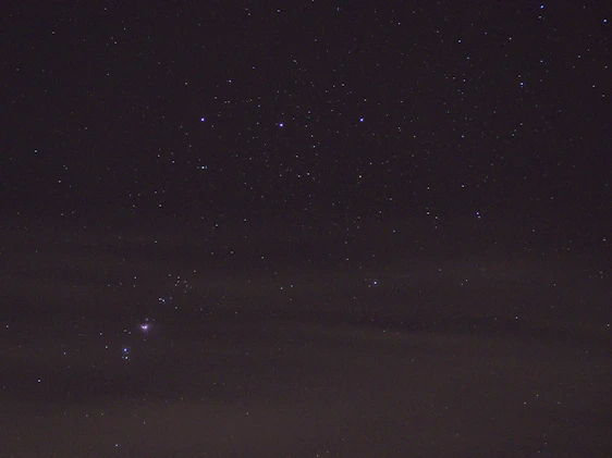 A glowing celestial map with stars and constellations softly illuminated against a deep purple night sky.