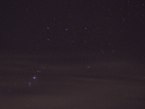 A serene purple nebula blending into a starry night sky with mystical symbols subtly glowing.