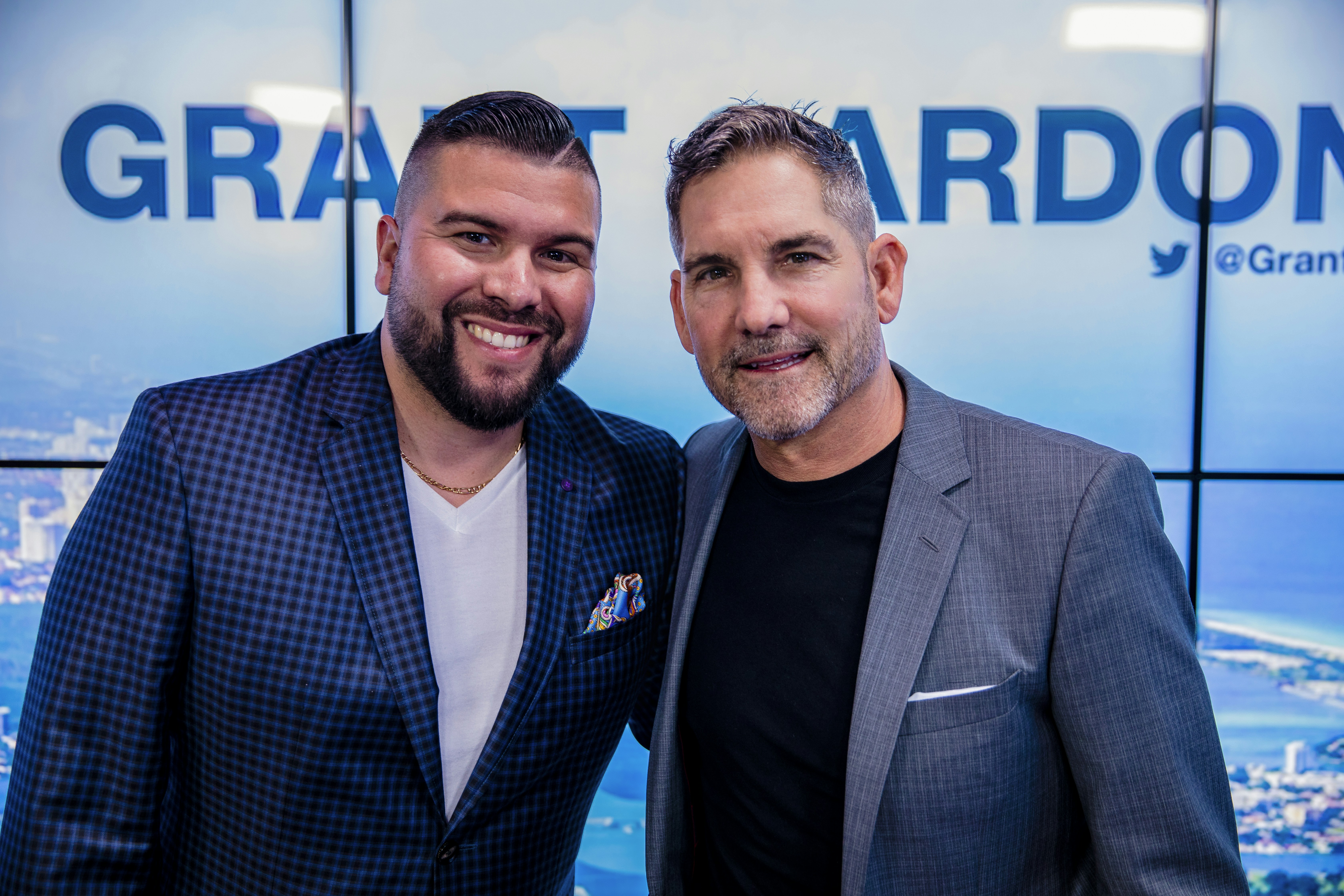 2 men in black suit smiling