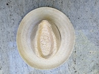 Artisan carefully selecting premium materials for soohl custom hat creation.