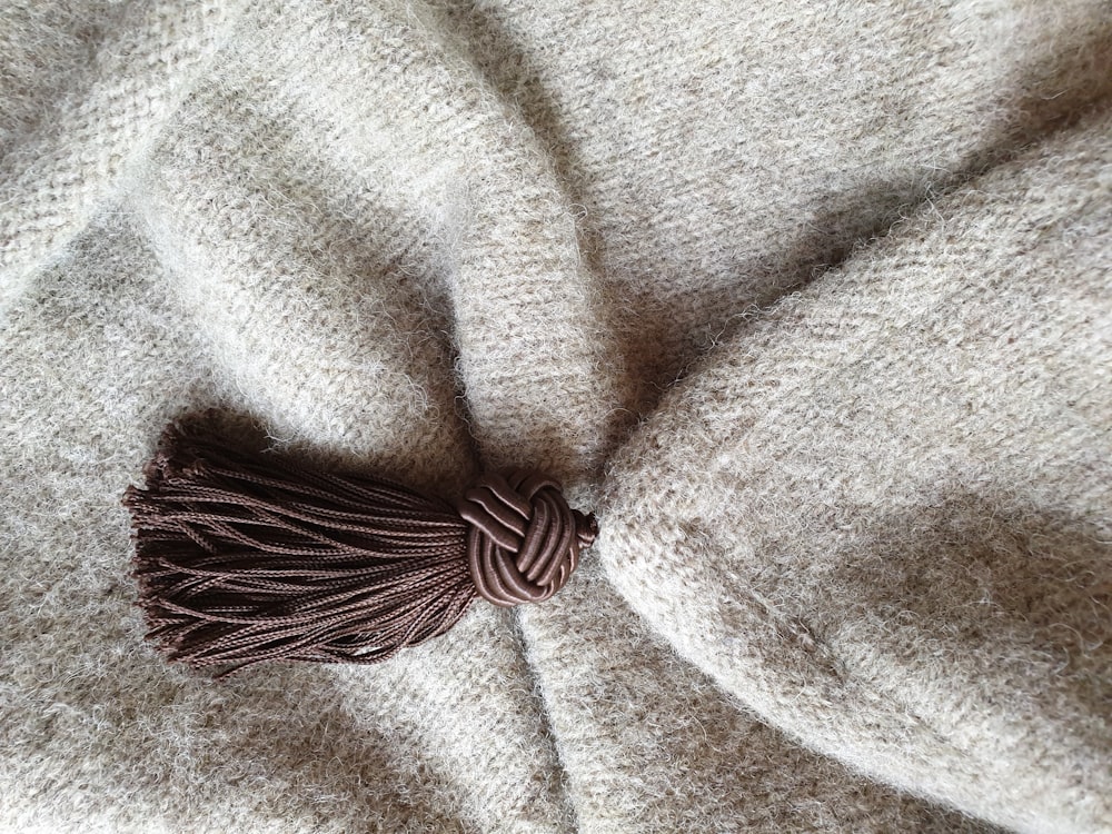 a close up of a blanket with a tassel