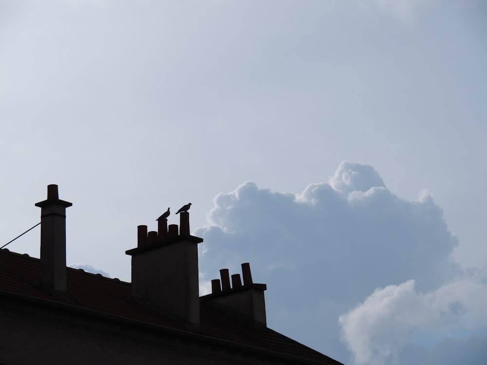 brown concrete building under white clouds during daytime