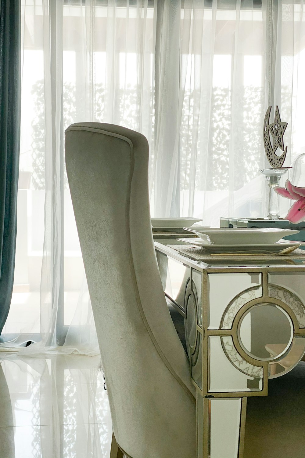 white wooden table near white window curtain