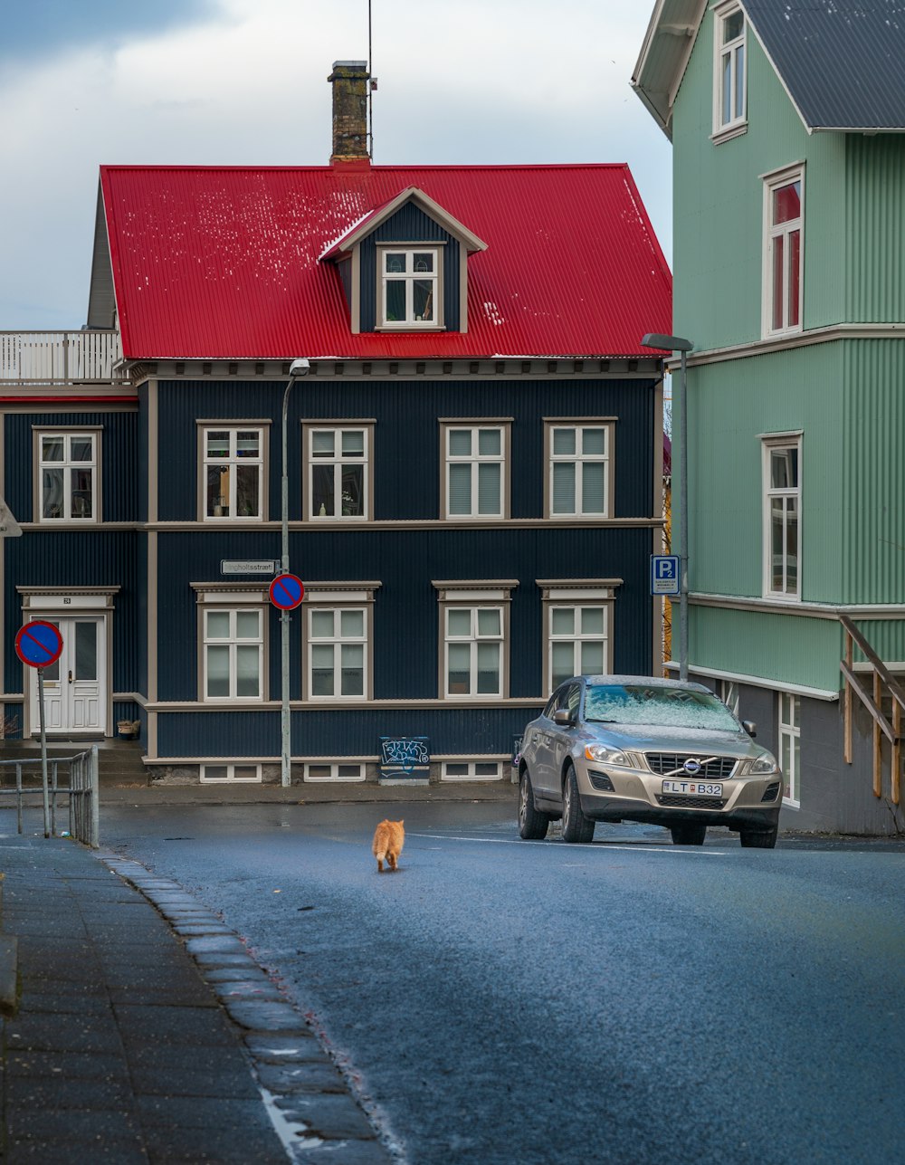 cars parked in front of red and white building