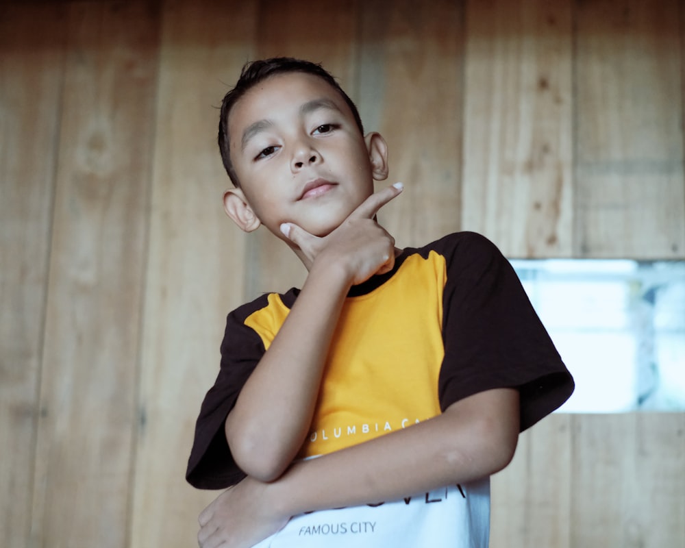 boy in black and yellow crew neck t-shirt